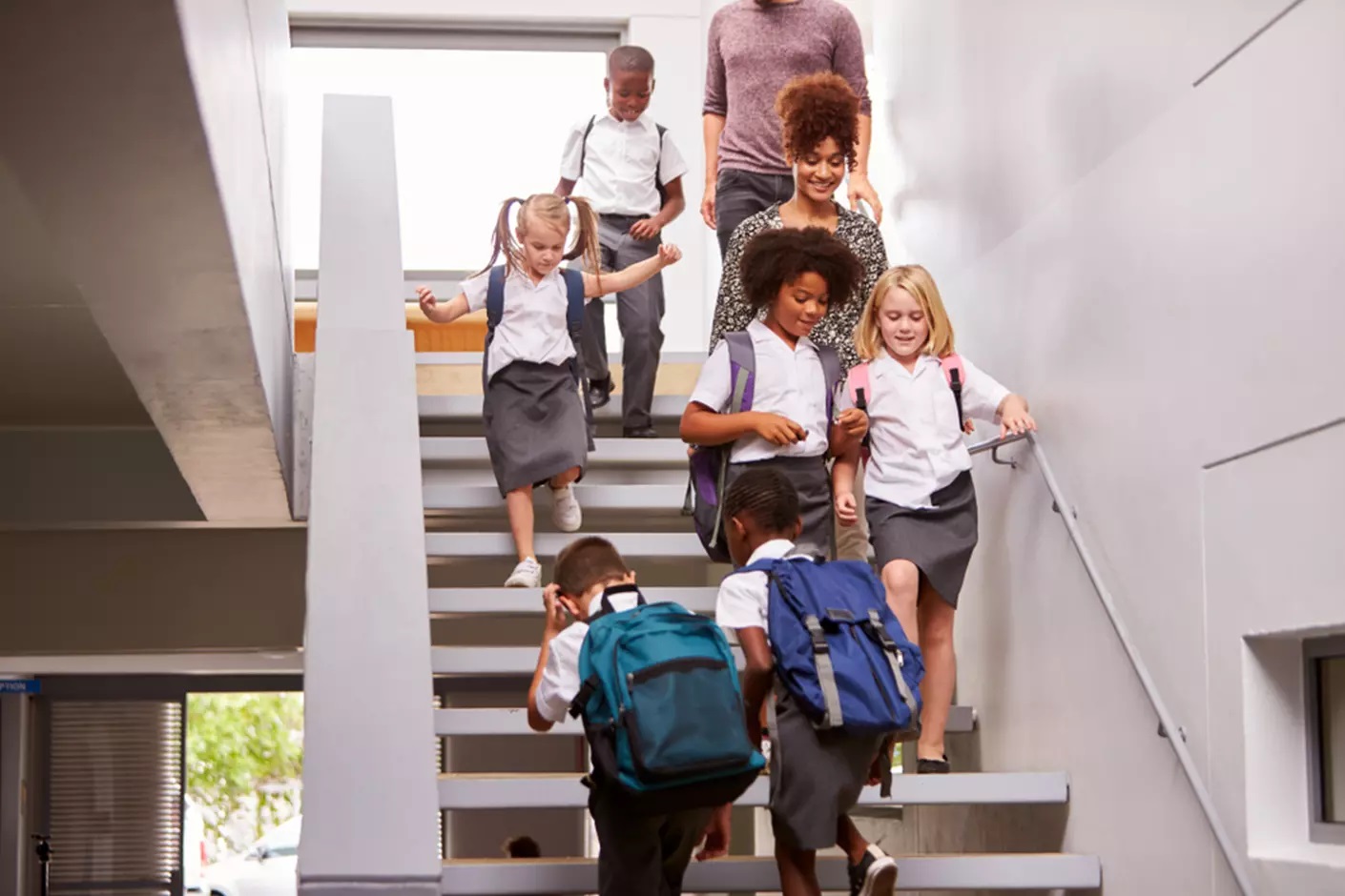 students walking down stairs in a school