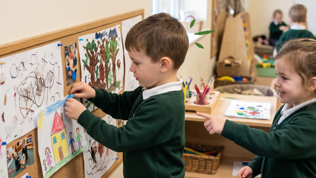 Early year students using a display board