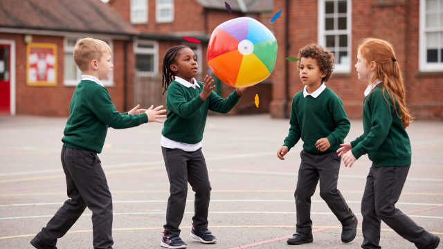 Students playing with a beach ball