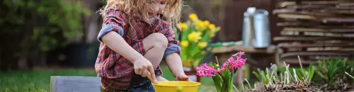 girl_gardening_with_yellow_bucket_and_flowers